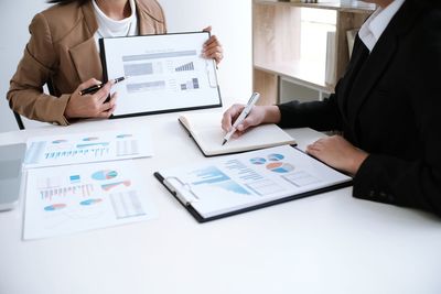 Close-up of business colleagues working in office