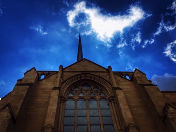 Low angle view of church against cloudy sky