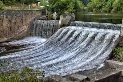 River water flowing through dam