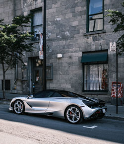 Car on street against building in city