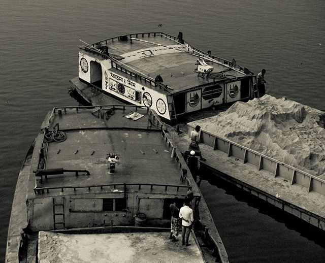 lifestyles, transportation, water, men, mode of transport, nautical vessel, leisure activity, built structure, architecture, high angle view, full length, person, boat, travel, walking, rear view, river