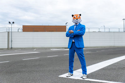 Full length of man standing on road against sky