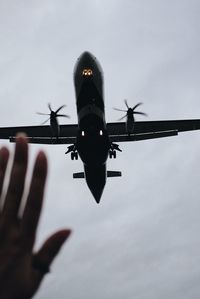 Low angle view of airplane flying against sky