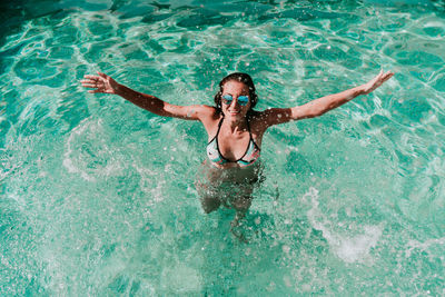 High angle view of woman swimming in pool