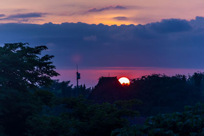 Silhouette trees against sky during sunset