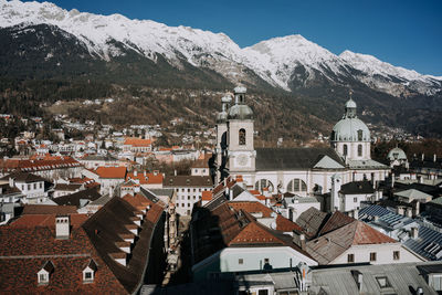 High angle view of townscape and mountains against sky