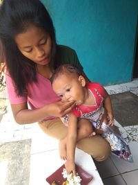 Mother and daughter sitting outdoors