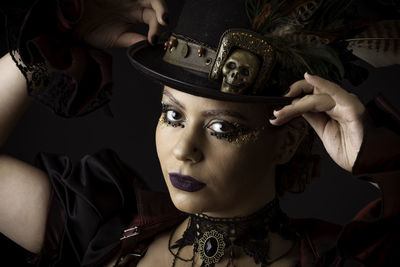 Woman in costume against black background