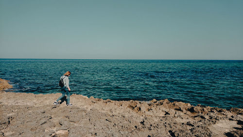 Woman against sea against clear sky