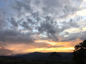 Scenic view of silhouette mountains against sky during sunset