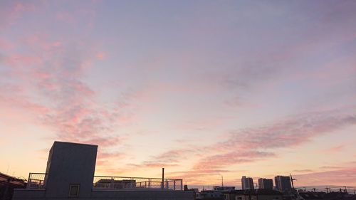 Silhouette buildings against sky during sunset