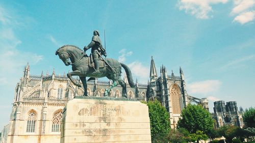 Low angle view of statue against blue sky