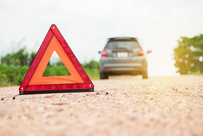 Low angle view of broken sign on road