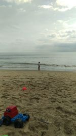 Man on beach against sky