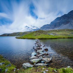 Scenic view of lake and mountains against sky