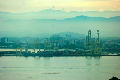 Scenic view of sea by city against sky