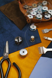 Seamstress workplace accessories. close up view of the eco leather and tailoring equipment 