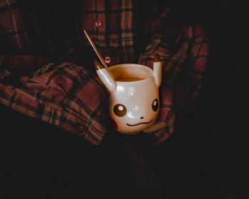 High angle view of coffee cup on bed