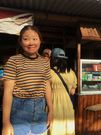 Woman making face looking away while standing outdoors