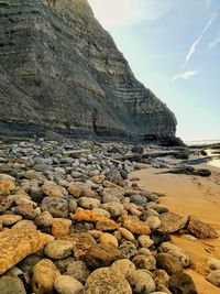 Scenic view of rocks in sea against sky