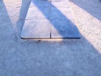 High angle view of shadow on frozen road