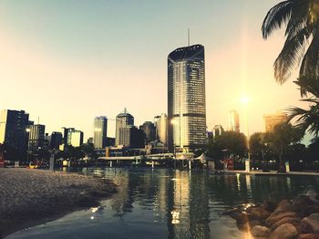 Brisbane cityscape against clear sky during sunset