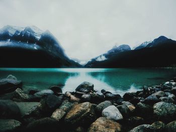 Scenic view of sea and mountains against sky