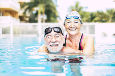 Portrait of smiling woman swimming in pool