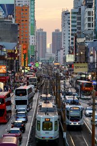 Traffic on city street amidst buildings