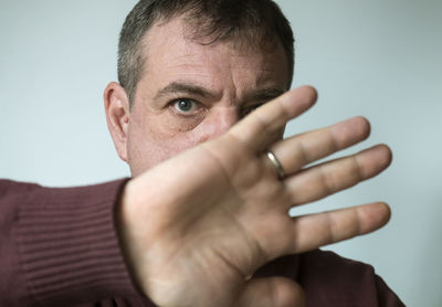 Portrait of man stopping against blue background