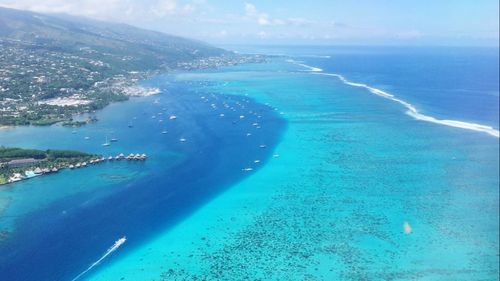 Aerial view of blue sea against sky