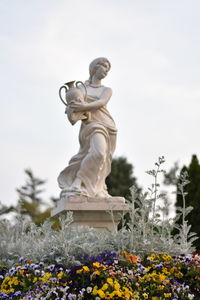 Low angle view of statue against cloudy sky