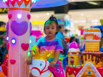 Portrait of cute girl standing in amusement park