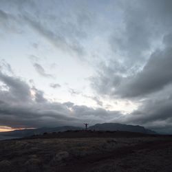 Man standing on landscape against sky