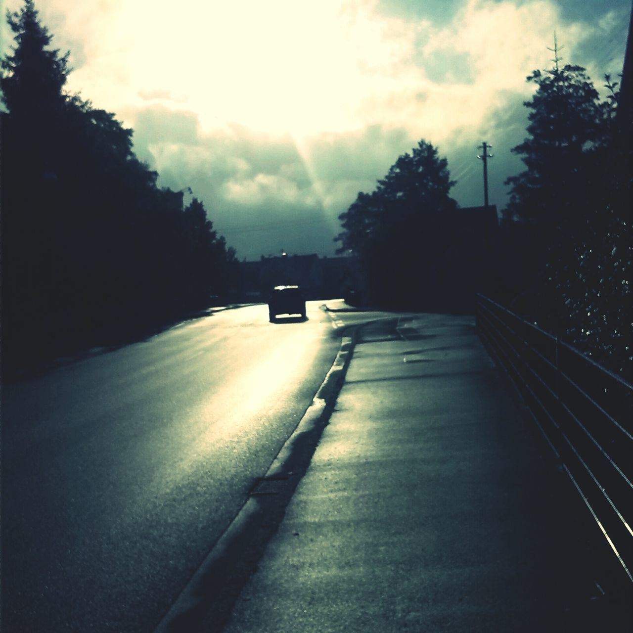 transportation, the way forward, tree, road, sky, diminishing perspective, vanishing point, cloud - sky, silhouette, street, car, road marking, sunset, sunlight, empty, street light, tranquility, no people, outdoors, mode of transport