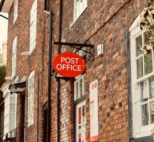 Low angle view of road sign against building