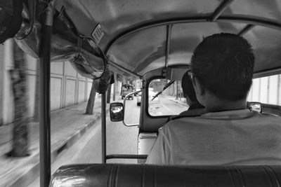 Rear view of man sitting in car