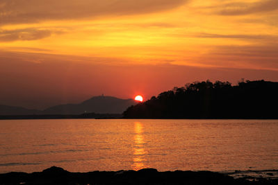 Scenic view of sea against romantic sky at sunset