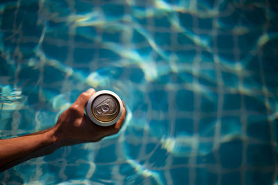 Cropped hand of person holding water