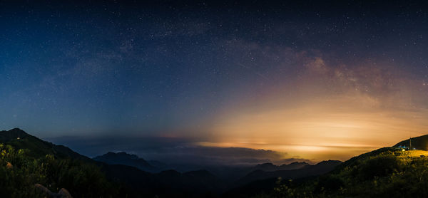 Scenic view of mountains against sky at night