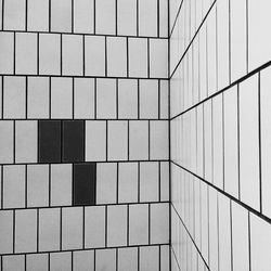 A wall covered in white and black ceramic tiles