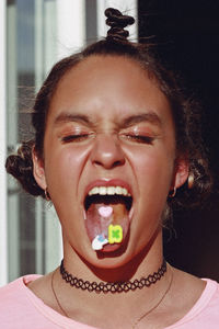 Close-up of girl eating candies at home