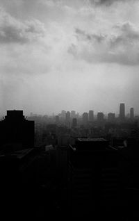 Buildings against cloudy sky