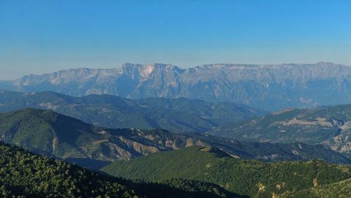 Scenic view of mountains against clear blue sky