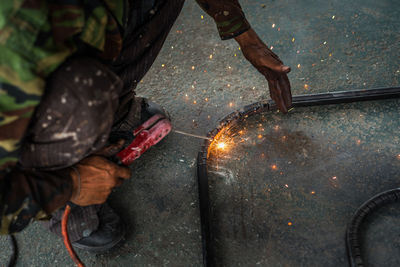 Low angle view of welder welding in workshop