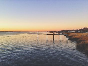 Scenic view of sea against clear sky during sunset