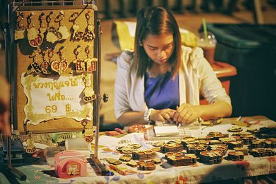 Woman selling key chains outdoors