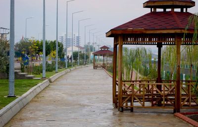 Footpath amidst buildings against sky