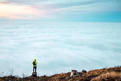 Amazing panorama of clouds floating all over the territory and a persistent boy of 20-25 years 