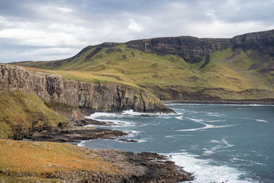 Scenic view of sea and mountains against sky